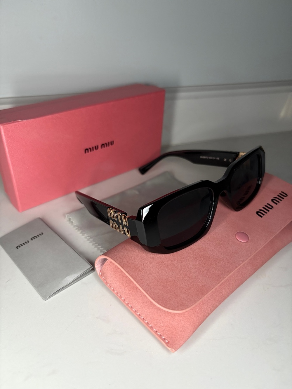 Miu Miu Black Sunglasses with Gold Logo Temples